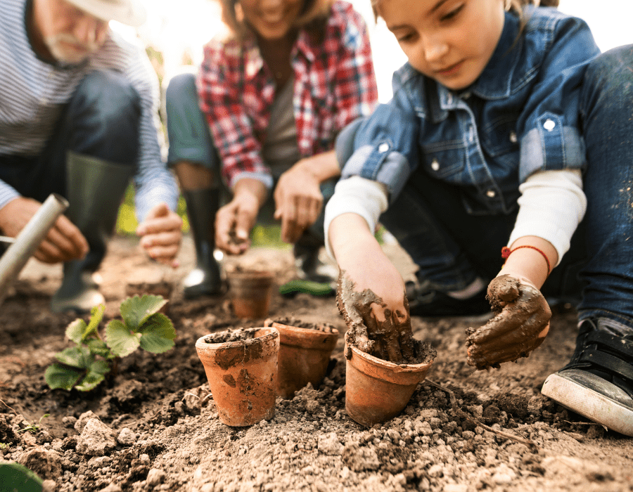 Child and their family practicing child safe gardening.