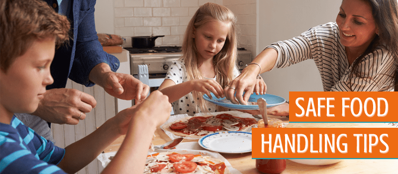family cooking pizza together