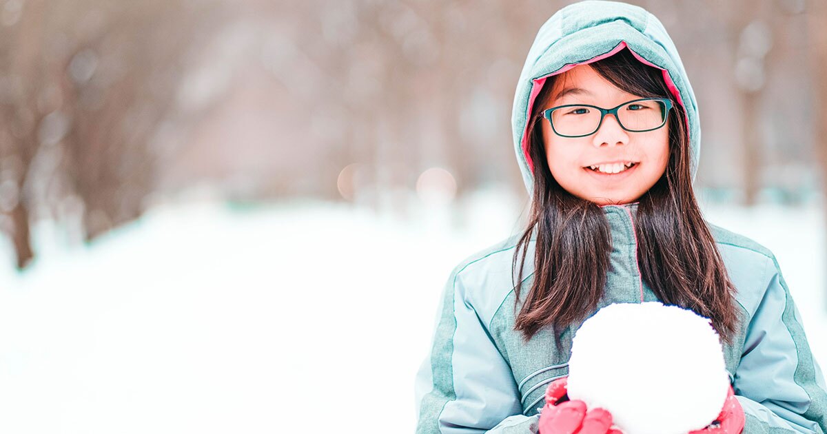 little girl holding a snowball
