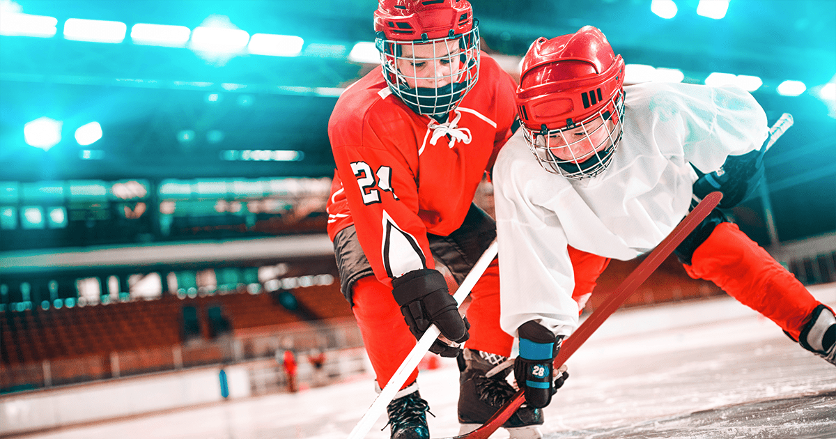 youth hockey players fighting for the puck