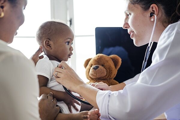 pediatrics Doctor using stethoscope on child