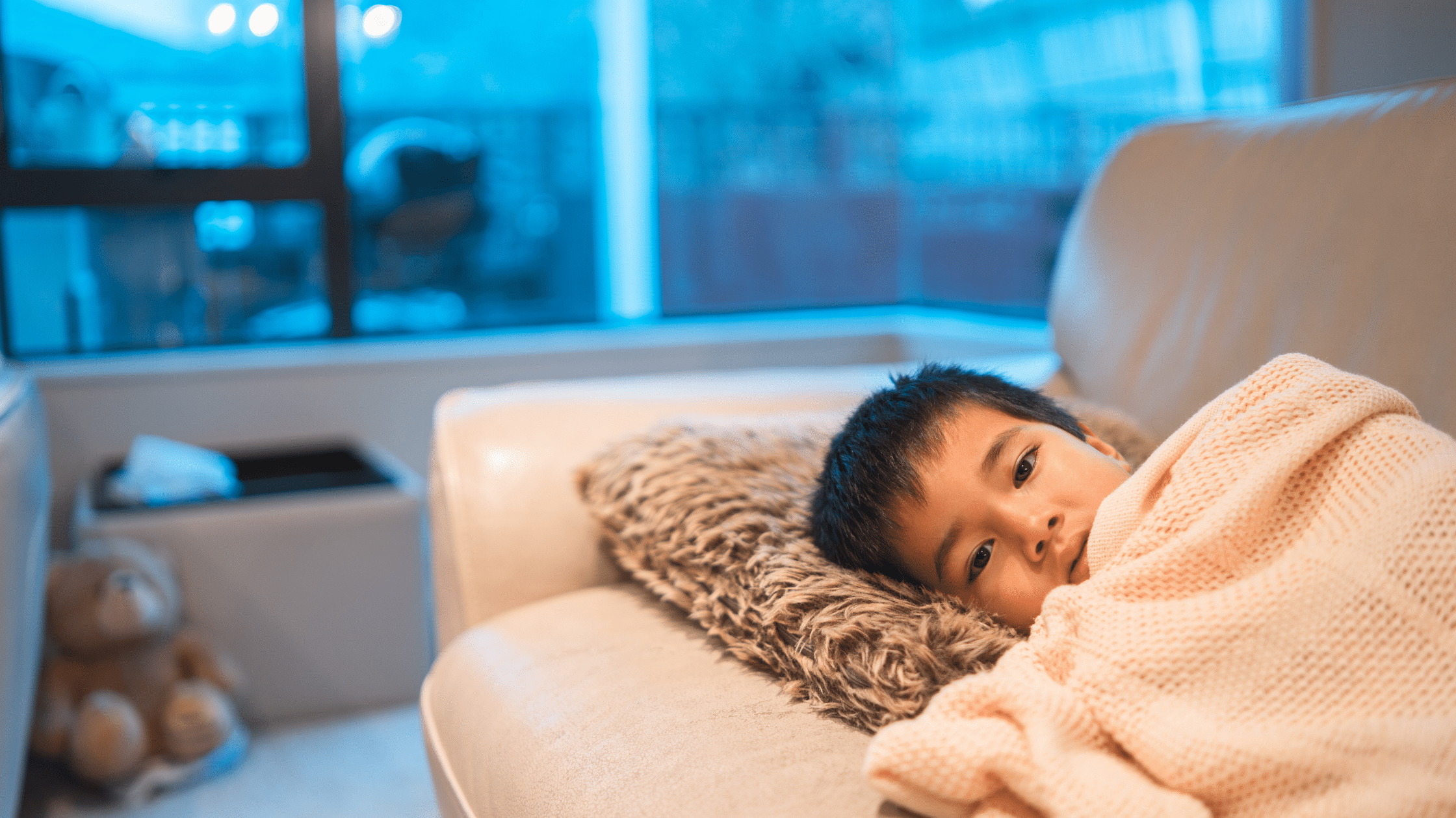 kid sick with the cold under the blankets