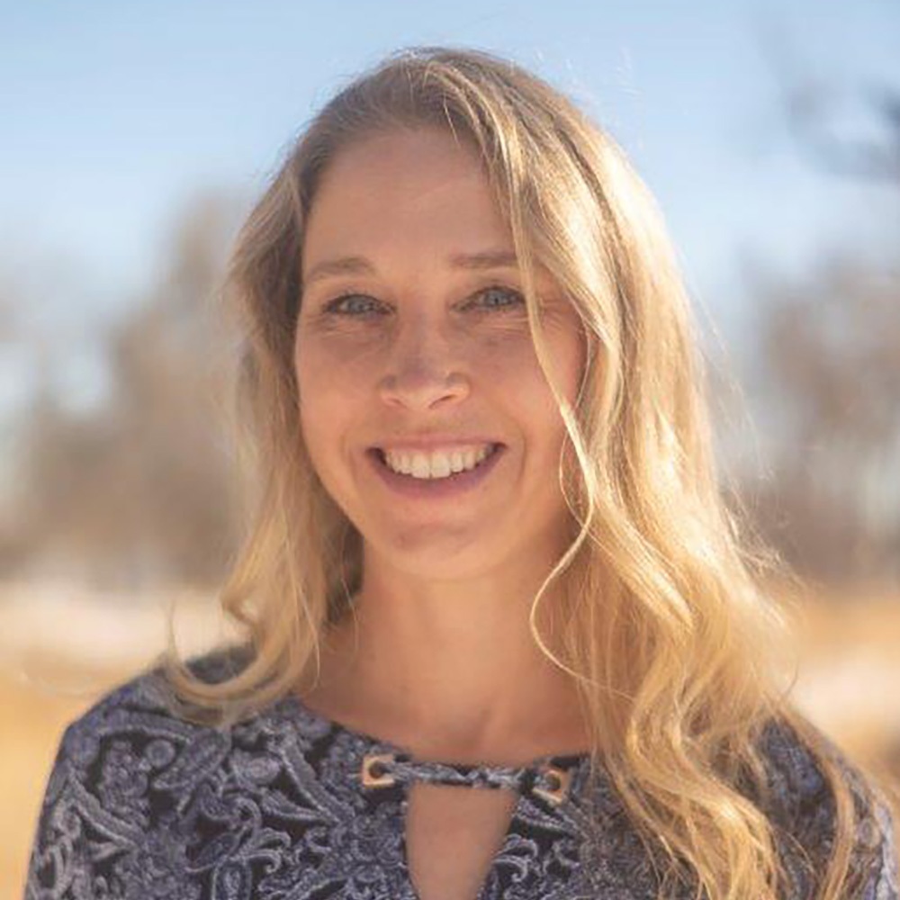 woman smiling while standing outside